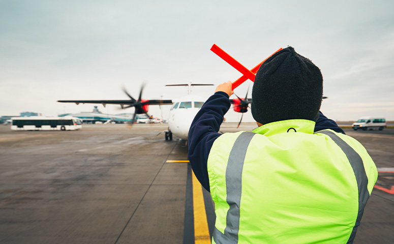 ground crew directing aircraft