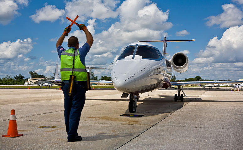 ground crew directing aircraft