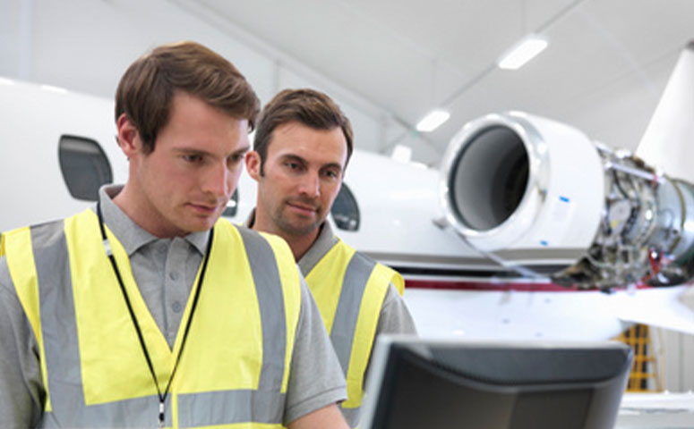 aircraft mechanics looking at screen