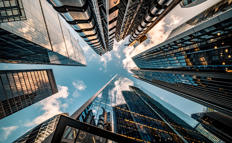 Looking directly up at the skyline of the financial district in central London